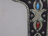 an image of a mirror with a decorative design on the side of it