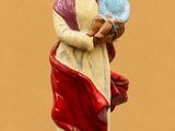 figurine of a woman holding a child in her arms