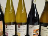 several bottles of wine are lined up in a row on a table