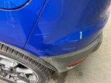 a close up of a blue car that is parked in a garage