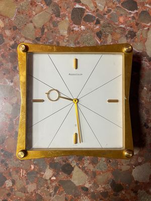 a clock that is sitting on a marble table
