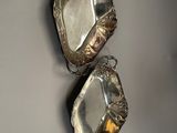 two silver trays hanging on a wall on a wall