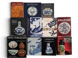 plusieurs livres sont empilés sur une surface blanche