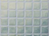 a picture of a tiled wall with a clock on the top of it