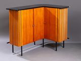 a wooden cabinet with a black top and a black counter top