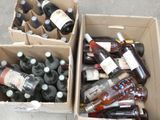many bottles of wine in a box on the ground