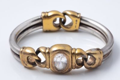 an image of a close up of a silver and gold bracelet