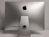 an apple computer sitting on top of a white desk