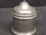 a silver container with a cross on top of it