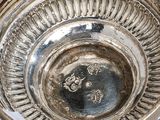 a silver plate with a design on it sitting on a table