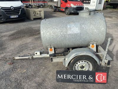 a trailer with a tank attached to it in a parking lot