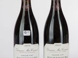 deux bouteilles de vin posées l'une à côté de l'autre sur une surface blanche
