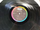 a black vinyl record with a colorful label on it