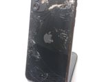 a broken iphone that is sitting on a stand