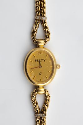 an image of a close up of a watch on a white surface