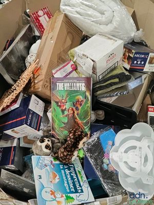 a cardboard box full of books and other items
