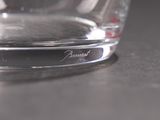 a glass of water sitting on a table next to a glass of water