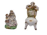 two figurines that are sitting next to each other
