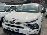 a white car parked in a parking lot next to other cars