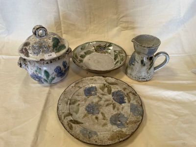 a plate, a bowl, and two cups on a table