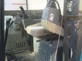 an image of a truck with a seat and a bucket