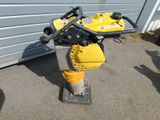 a small yellow machine that is sitting on the ground