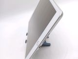 a tablet computer sitting on a stand on a white surface