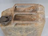 an old metal canister with a handle on it