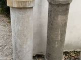 two cement pipes on the ground next to a cement wall