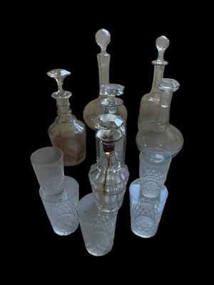 a lot of glass bottles that are sitting on a table