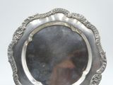 a silver plate with a mirror in the middle of it