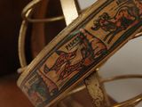 a gold bracelet with a picture of a man and a woman on it