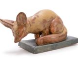 statue of a cat on a base on a white background