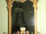 a fireplace with a mantle and a mirror on it