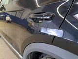 a close up of a car door handle with a sticker on it