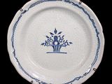 a blue and white plate with a flower design on it