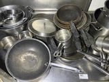 many pots and pans that are sitting on the stove