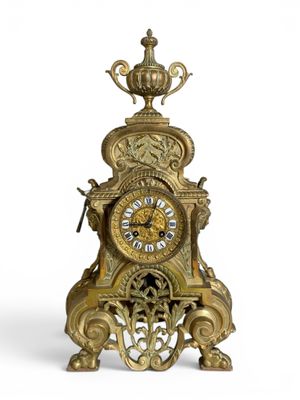 a gold clock with a crown on top of it
