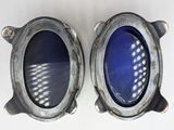 two oval mirrors that are sitting on a white surface