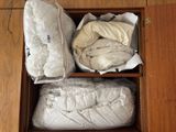 a box with two pillows and a blanket in it