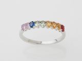 a multicolored rainbow stone ring on a white background