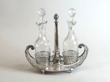 a silver plate with two bottles and a spoon on it