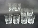 six glasses are lined up in a row on a black surface
