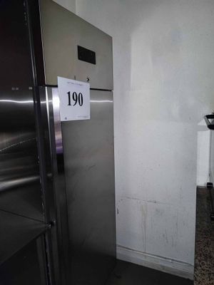 an image of a refrigerator in a kitchen with a price tag on the door