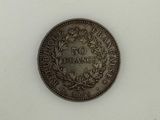 a close up of a coin on a table with a white background