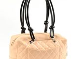 chanel beige quilted leather handbag with black leather handles
