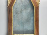 a wooden frame with a mirror on it on the wall