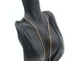 a close up of a mannequin head with a necklace on it