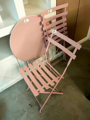 une chaise rose et une table rose dans une pièce