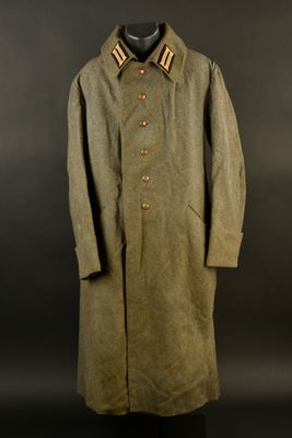 an old coat with a collar and buttons on a mannequin dummy